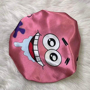 Blush pink side of the Cartoon Besties reversible satin bonnet