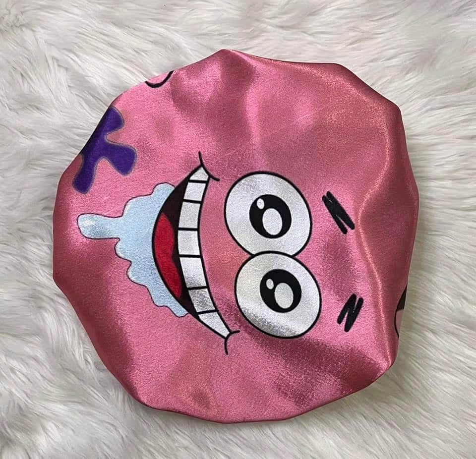 Blush pink side of the Cartoon Besties reversible satin bonnet