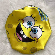 Yellow side of the Cartoon Besties reversible satin bonnet